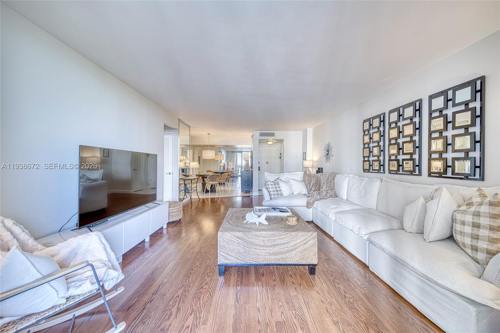 1111 Crandon Boulevard, Unit C404 Key Biscayne, FL 33149 - Photo 9 of 44 a living room with furniture and a flat screen tv