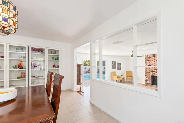 a living room with furniture a fireplace and a floor to ceiling window