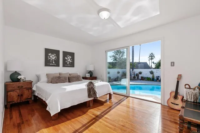 a bedroom with a bed and a potted plant on table