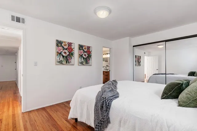 a bathroom with a granite countertop sink a mirror a glass door and shower