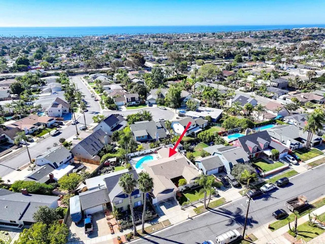 an aerial view of a houses with a swimming pool