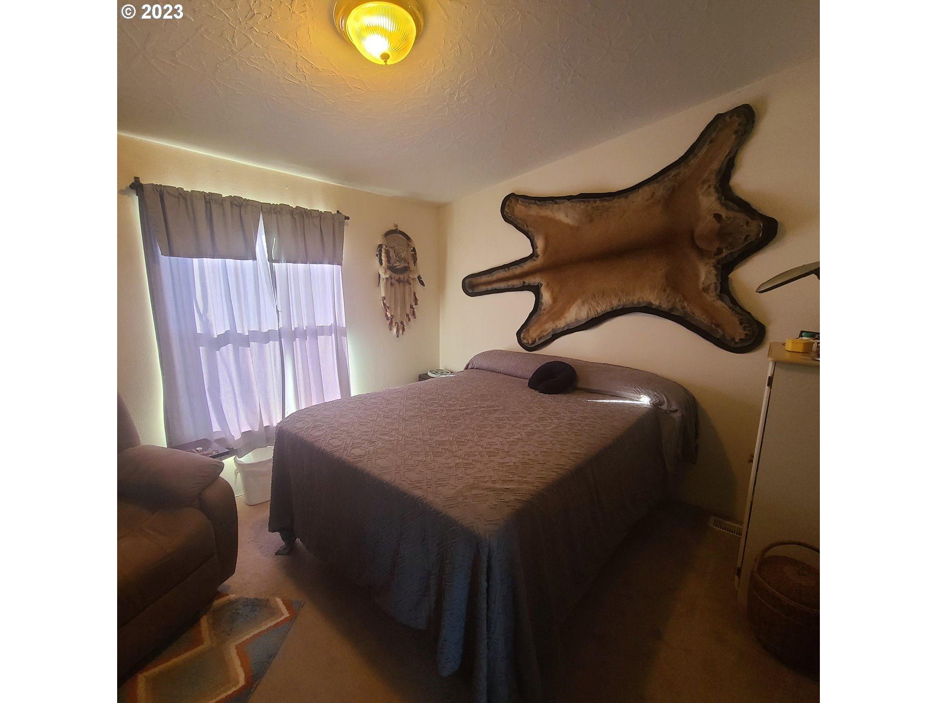 70775 Middle Road Elgin, OR 97827 - Photo 19 of 40 a bedroom with a bed and a chair