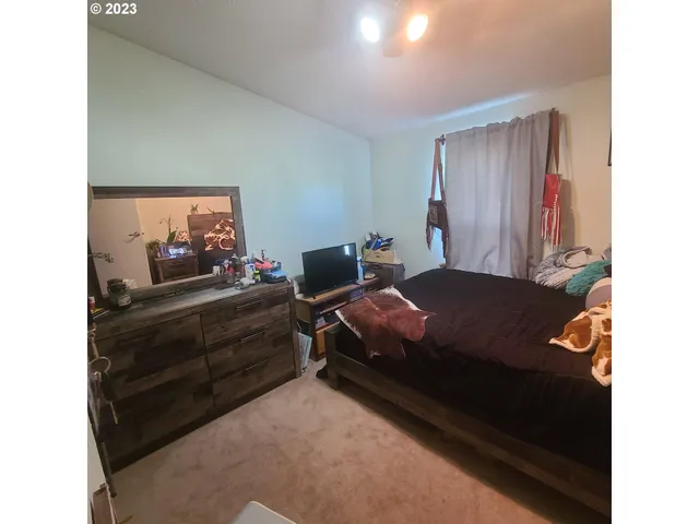 a bedroom with a bed and a window