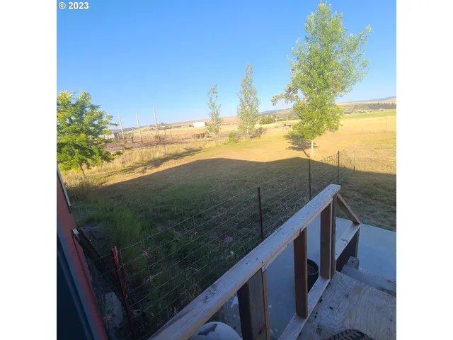a spacious bedroom with a bed and a chandelier