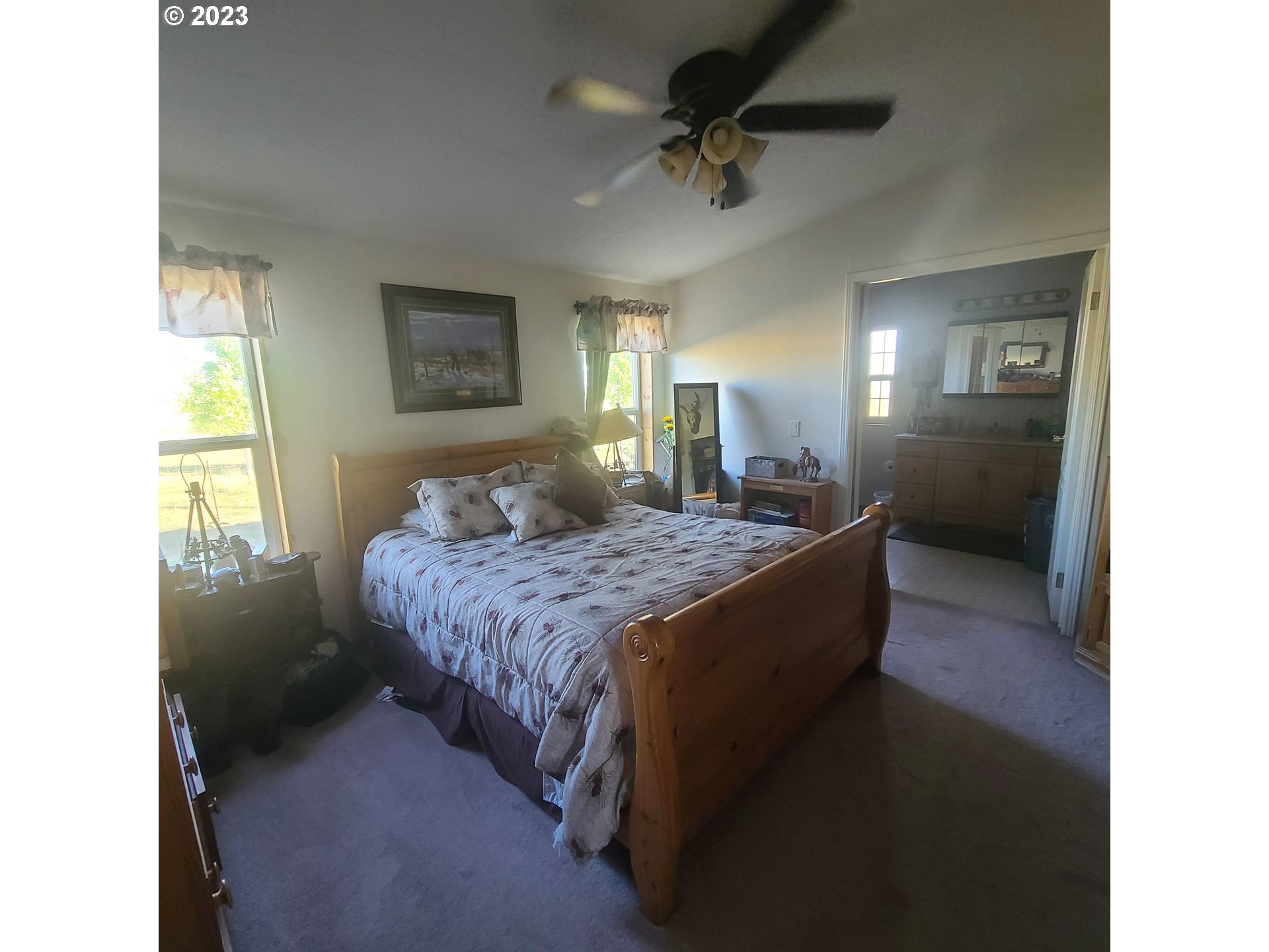 70775 Middle Road Elgin, OR 97827 - Photo 28 of 40 a spacious bedroom with a bed and a chandelier