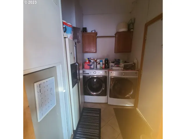 a kitchen with a sink window and cabinets