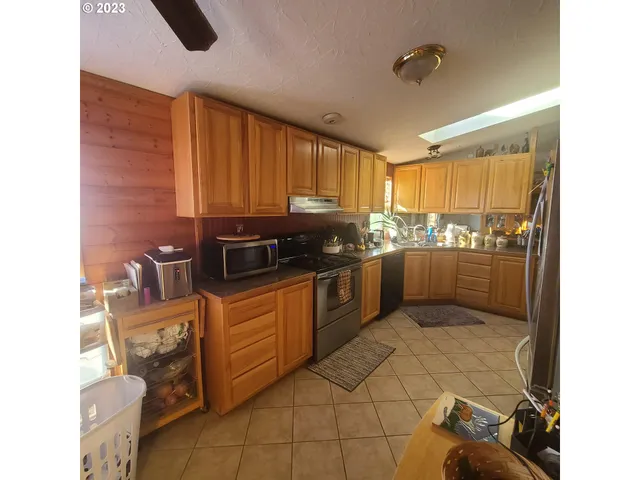 a kitchen with stainless steel appliances granite countertop a refrigerator and a stove