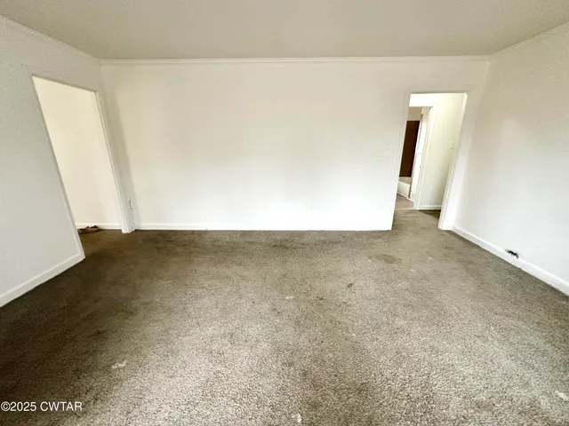 an empty room with wooden floor