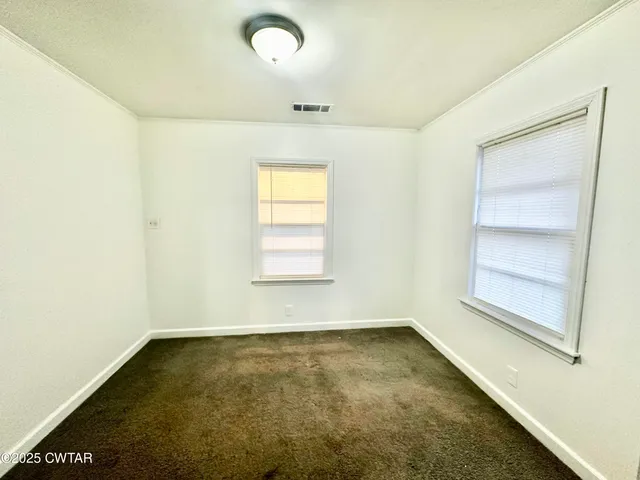 an empty room with a empty space and windows