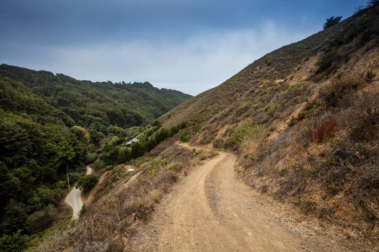 9661 Sycamore Canyon Road Big Sur, CA 93920 - Photo 10 of 26 a view of a dry yard with mountains in the background