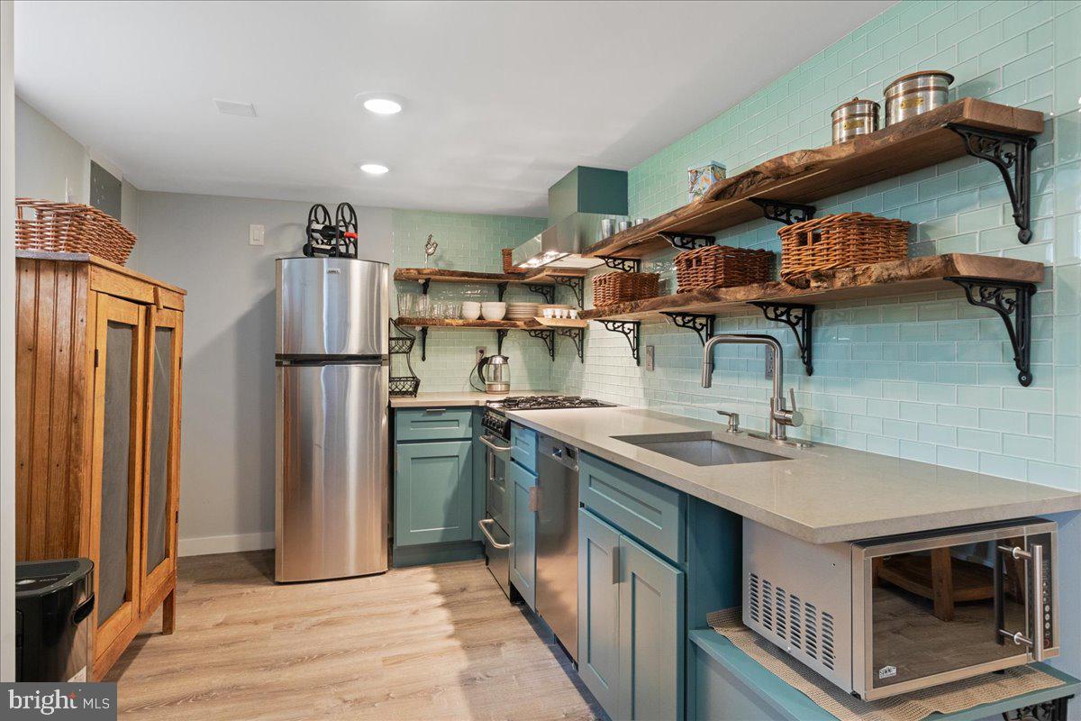 59 Longview Drive Princeton, NJ 08540 - Photo 20 of 30 a kitchen with stainless steel appliances granite countertop a sink a stove and a refrigerator