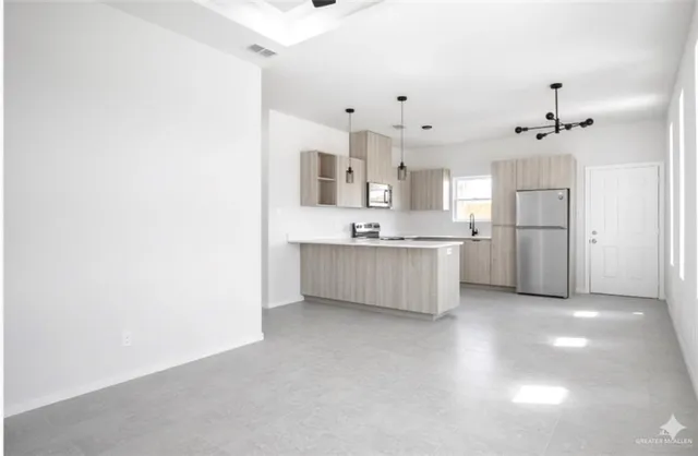 a large kitchen with cabinets and stainless steel appliances