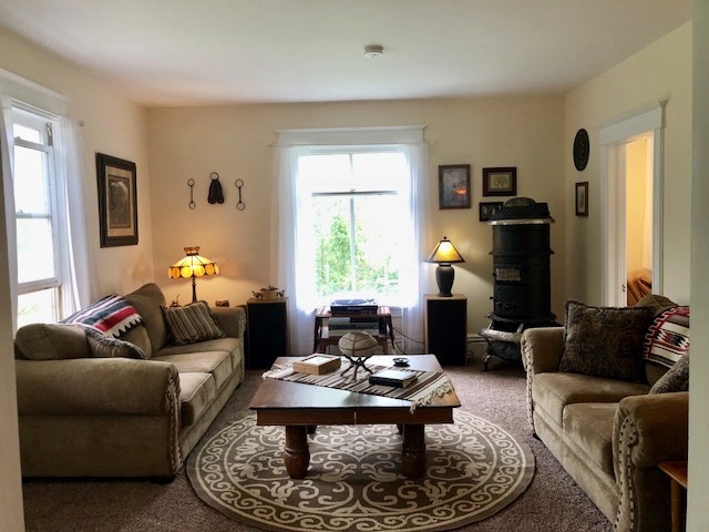 14964 Mill Road Capron, IL 61012 - Photo 14 of 25 a living room with furniture fireplace and a window