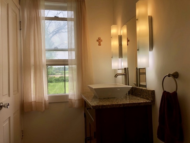 14964 Mill Road Capron, IL 61012 - Photo 22 of 25 a bathroom with a granite countertop sink and a mirror