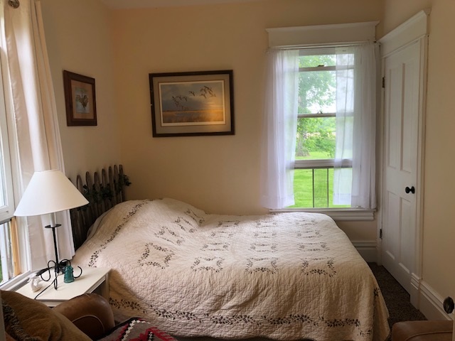 14964 Mill Road Capron, IL 61012 - Photo 23 of 25 a bedroom with a bed and a lamp