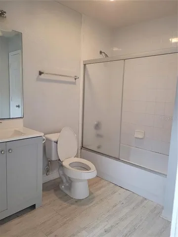 a bathroom with a toilet a sink and a mirror