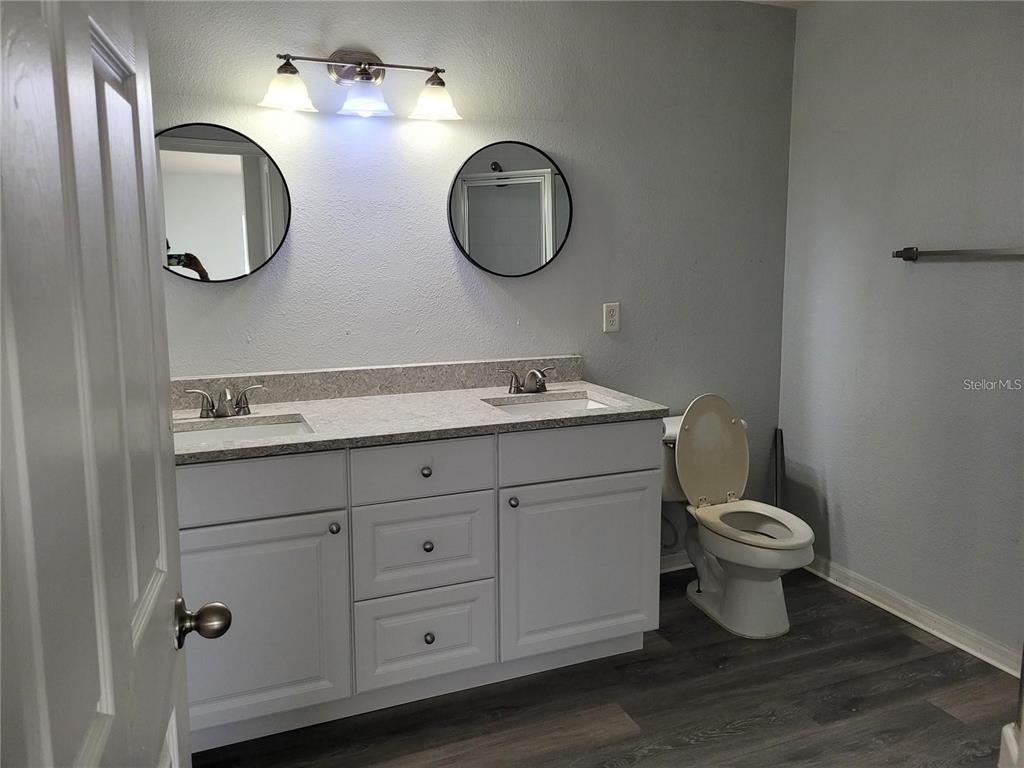 155 North Pearl Lake Causeway, Unit 200 Altamonte Springs, FL 32714 - Photo 15 of 21 a bathroom with a toilet a sink and a mirror