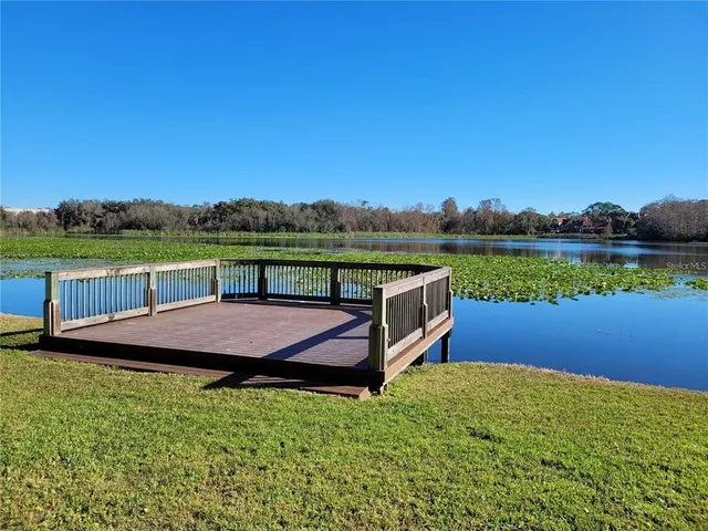 a view of a deck and a yard with green space