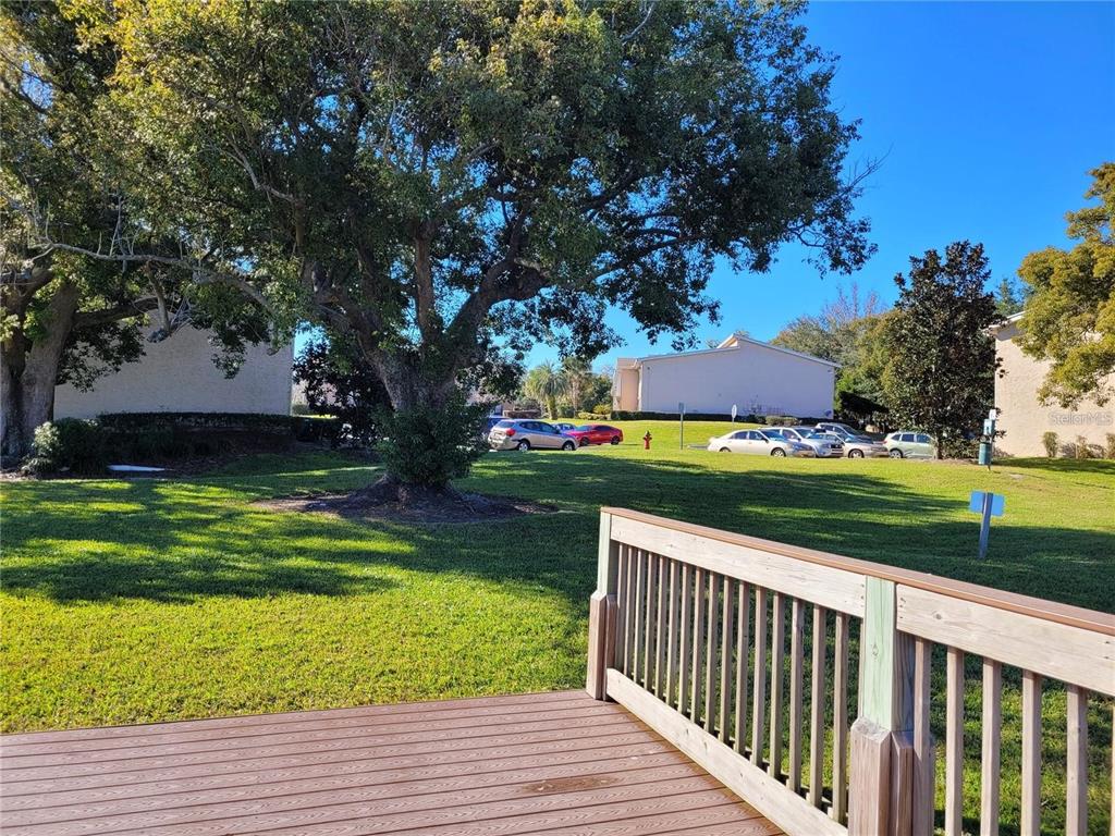 155 North Pearl Lake Causeway, Unit 200 Altamonte Springs, FL 32714 - Photo 20 of 21 a view of a deck and a yard with green space
