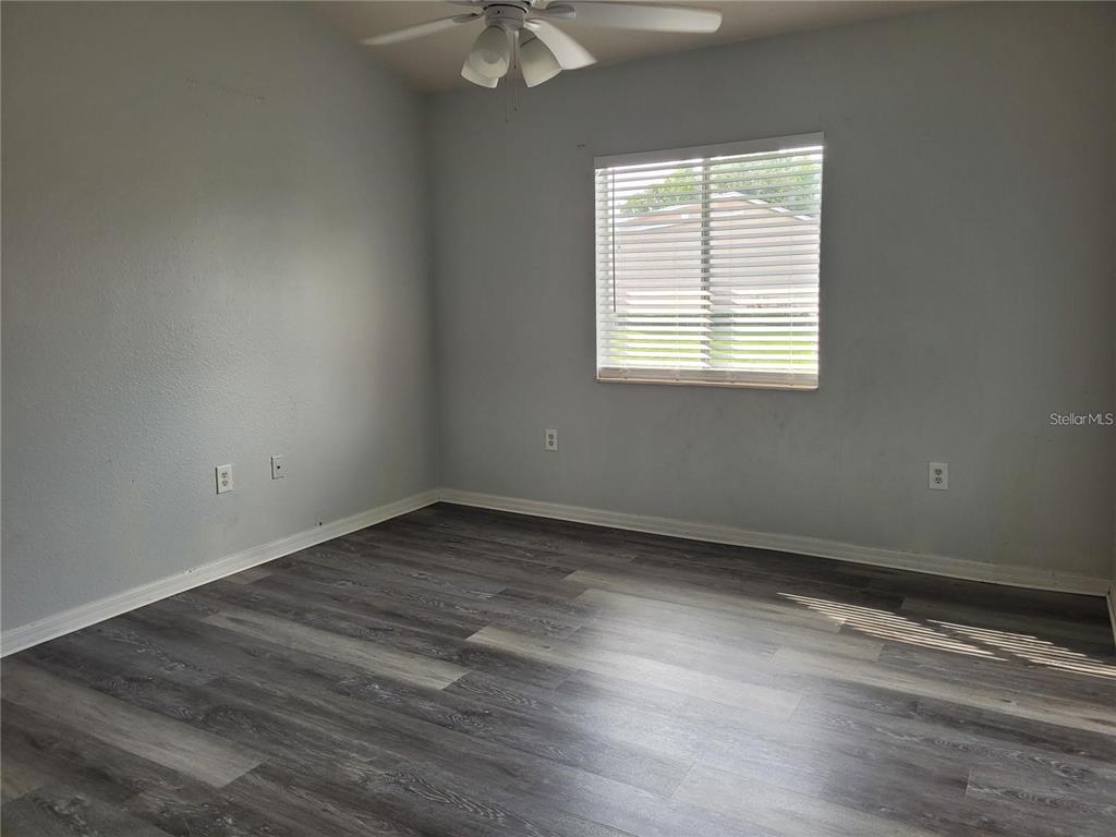 155 North Pearl Lake Causeway, Unit 200 Altamonte Springs, FL 32714 - Photo 3 of 21 an empty room with wooden floor and windows