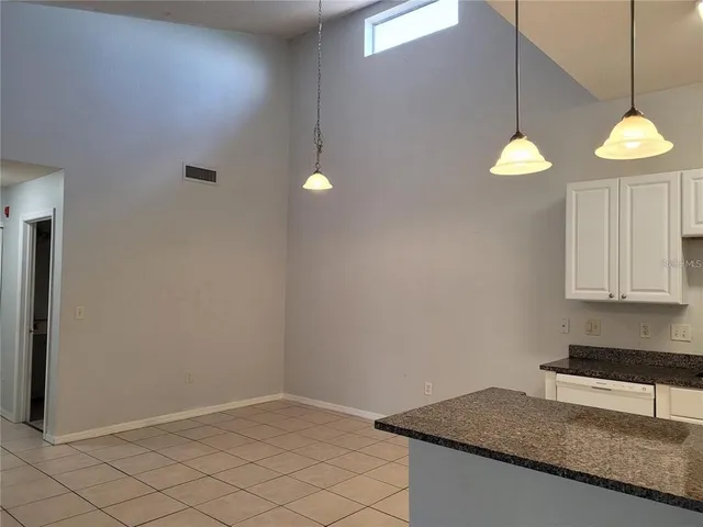 a kitchen with a cabinet and a granite counter top