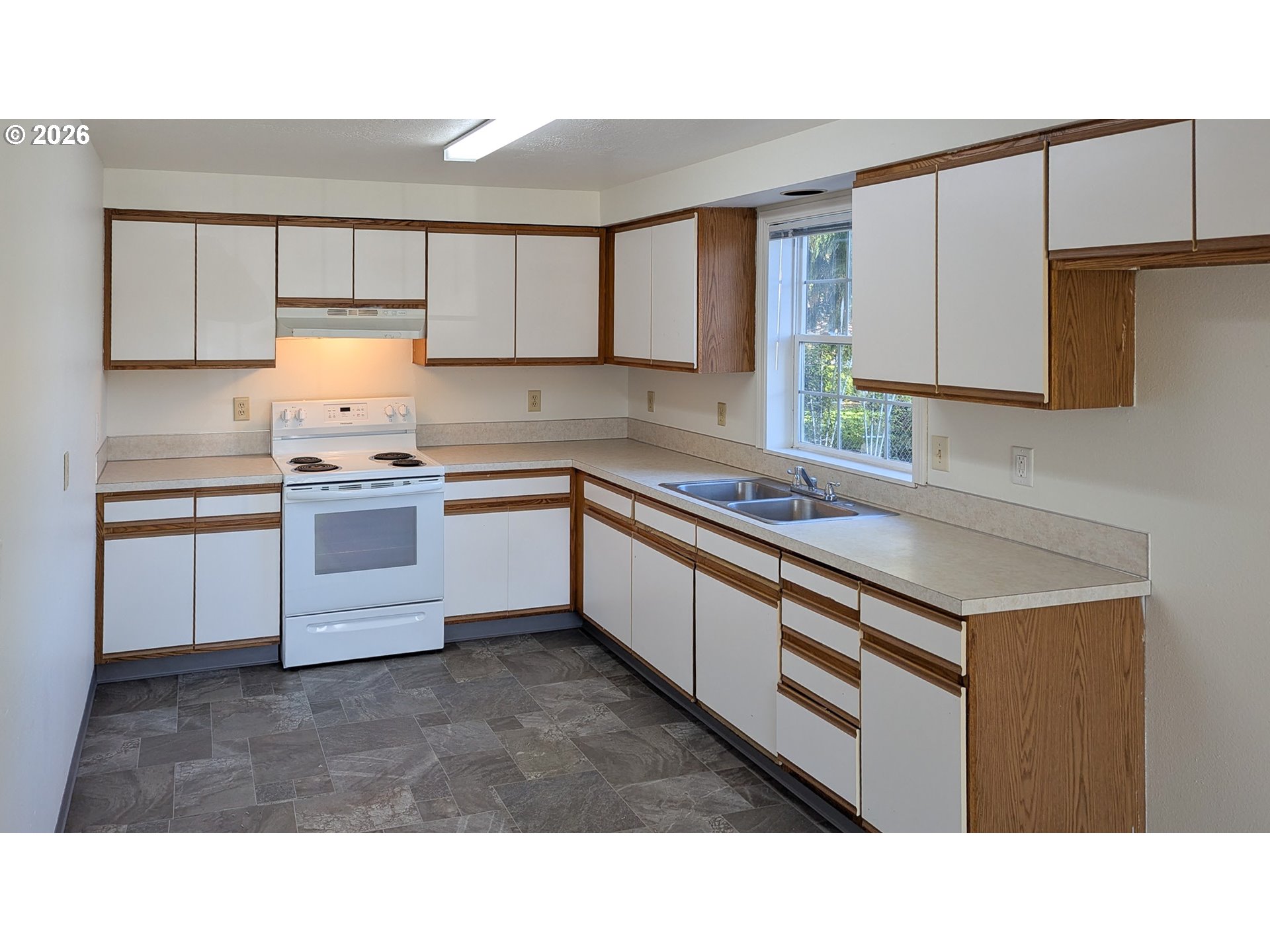 224 C Street Independence, OR 97351 - Photo 21 of 36 a kitchen with a sink window and cabinets