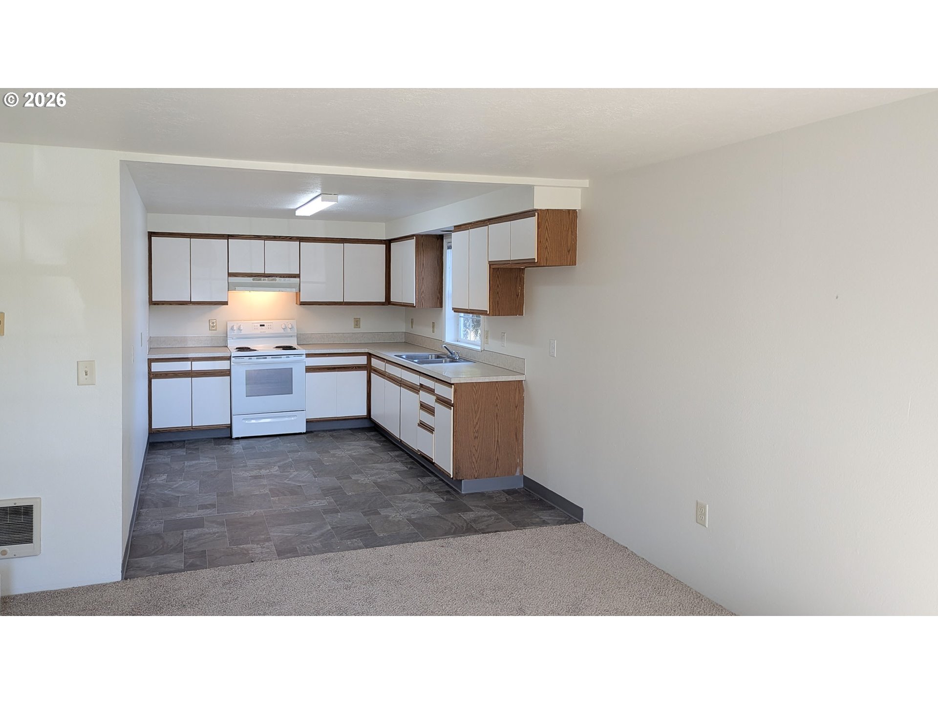 224 C Street Independence, OR 97351 - Photo 22 of 36 a kitchen with kitchen island a sink a stove and cabinets