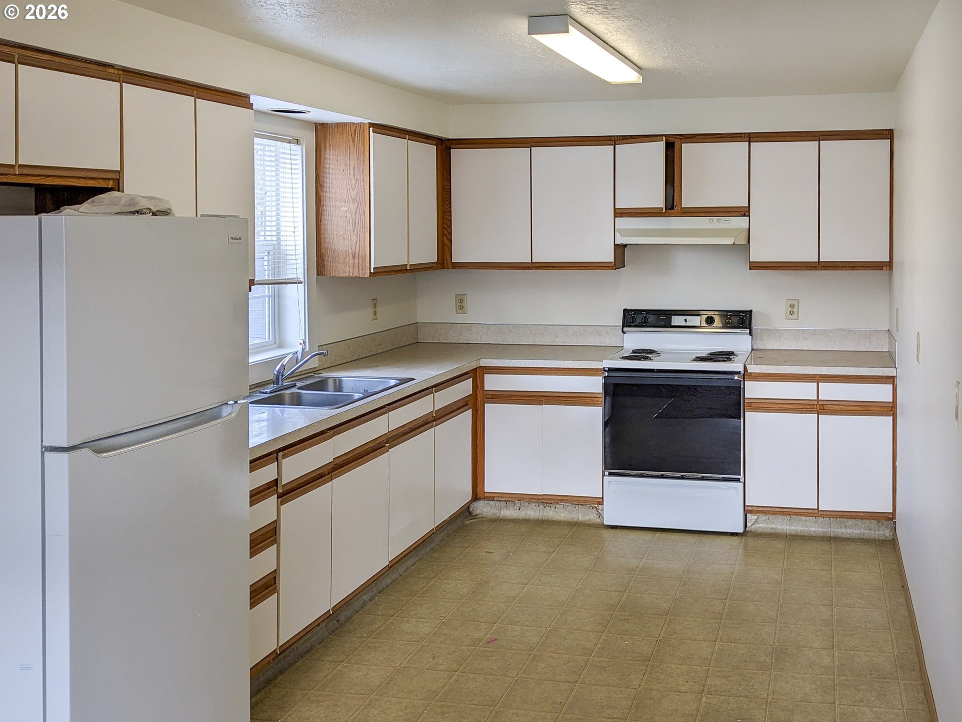 224 C Street Independence, OR 97351 - Photo 8 of 36 a kitchen with stainless steel appliances granite countertop a stove a refrigerator and a sink