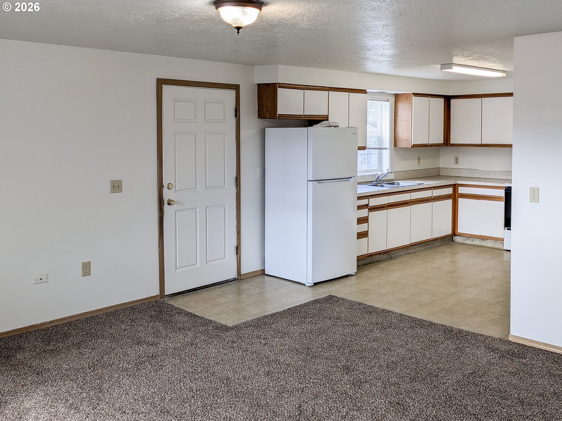 224 C Street Independence, OR 97351 - Photo 10 of 36 a large kitchen with cabinets and a wooden floors
