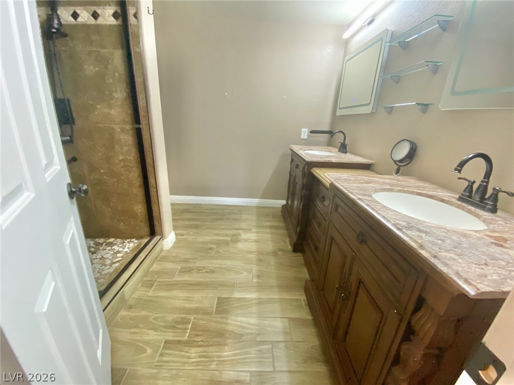 2000 Turquoise Ridge Street, Unit 204 Las Vegas, NV 89117 - Photo 5 of 29 Dual vanity sinks provide ample space for morning routines, complemented by the elegant tile flooring.