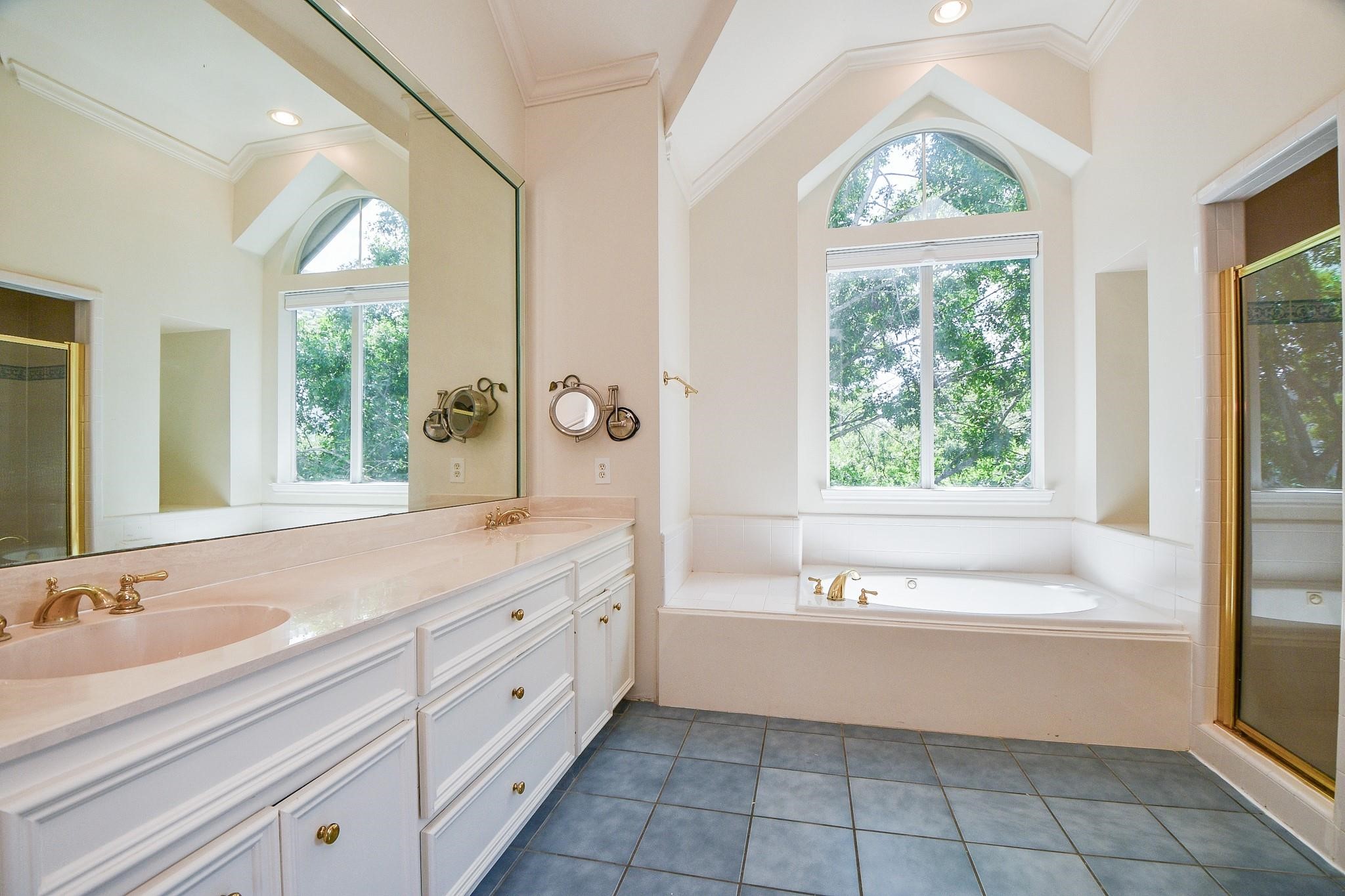 1025 Marconi Street Houston, TX 77019 - Photo 12 of 19 a bathroom with a bathtub a sink and a large window