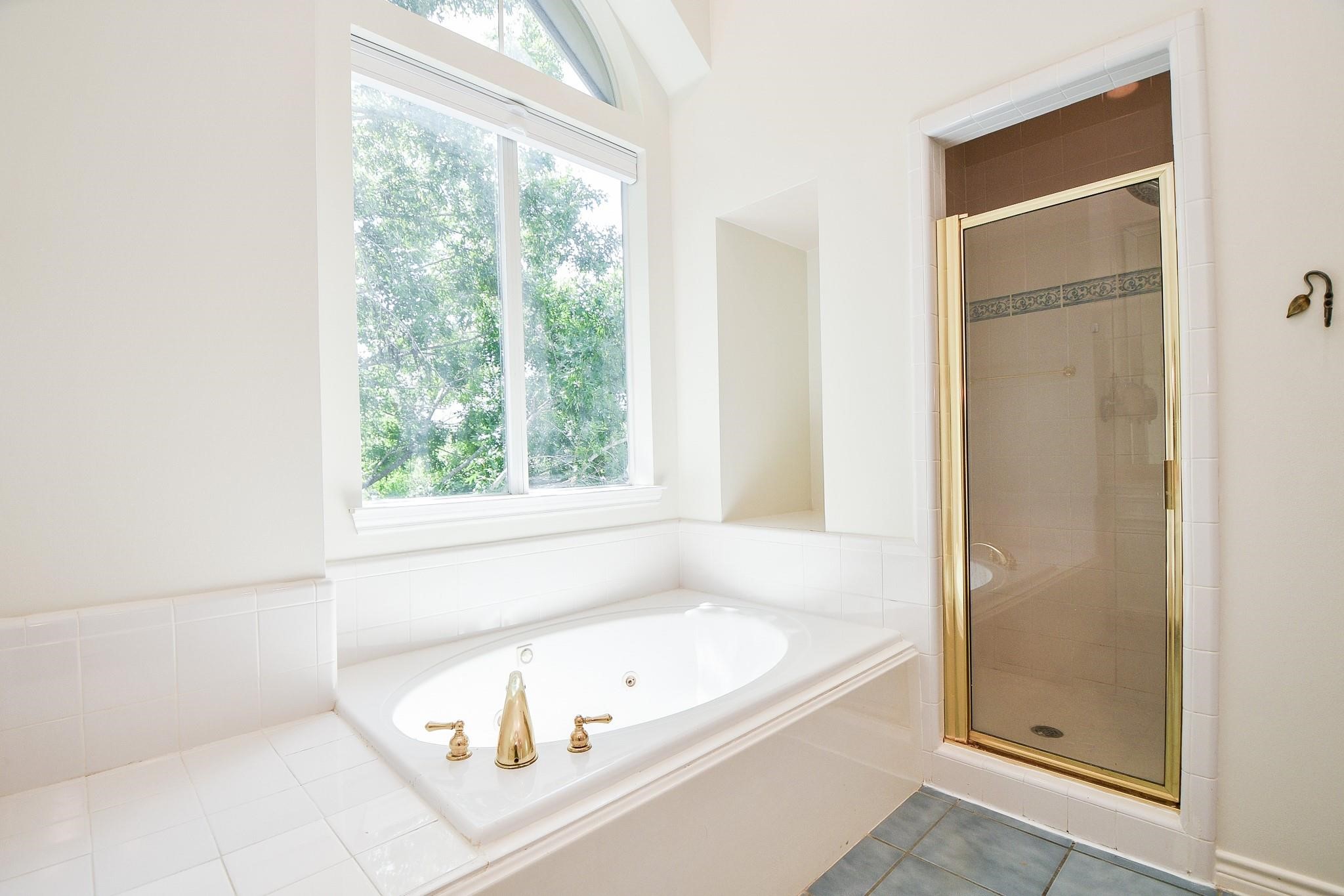1025 Marconi Street Houston, TX 77019 - Photo 13 of 19 a white bath tub sitting next to a window