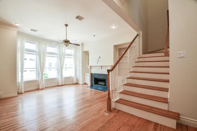 a view of entryway and hall with wooden floor