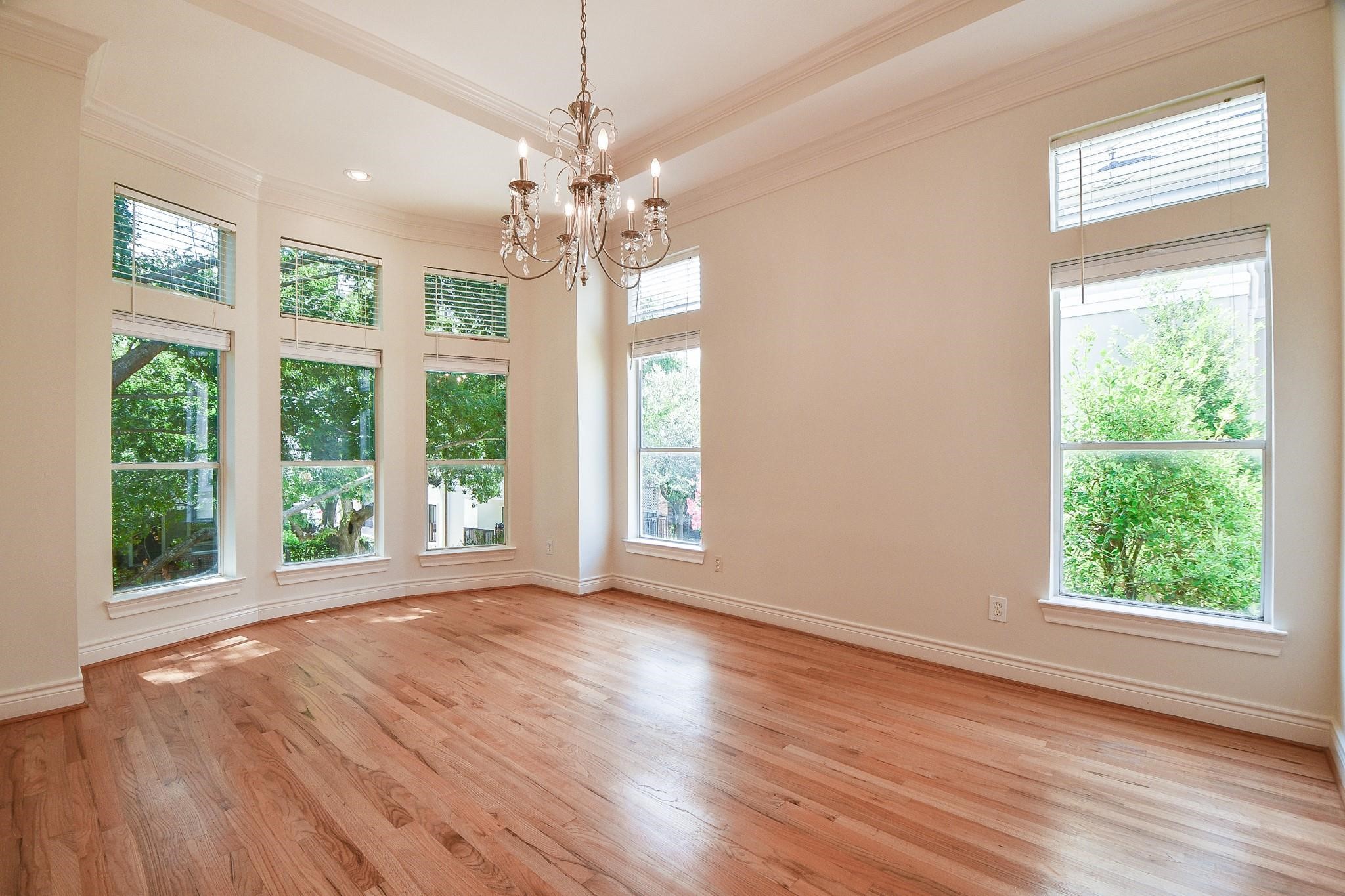 1025 Marconi Street Houston, TX 77019 - Photo 4 of 19 a view of an empty room with wooden floor and a window
