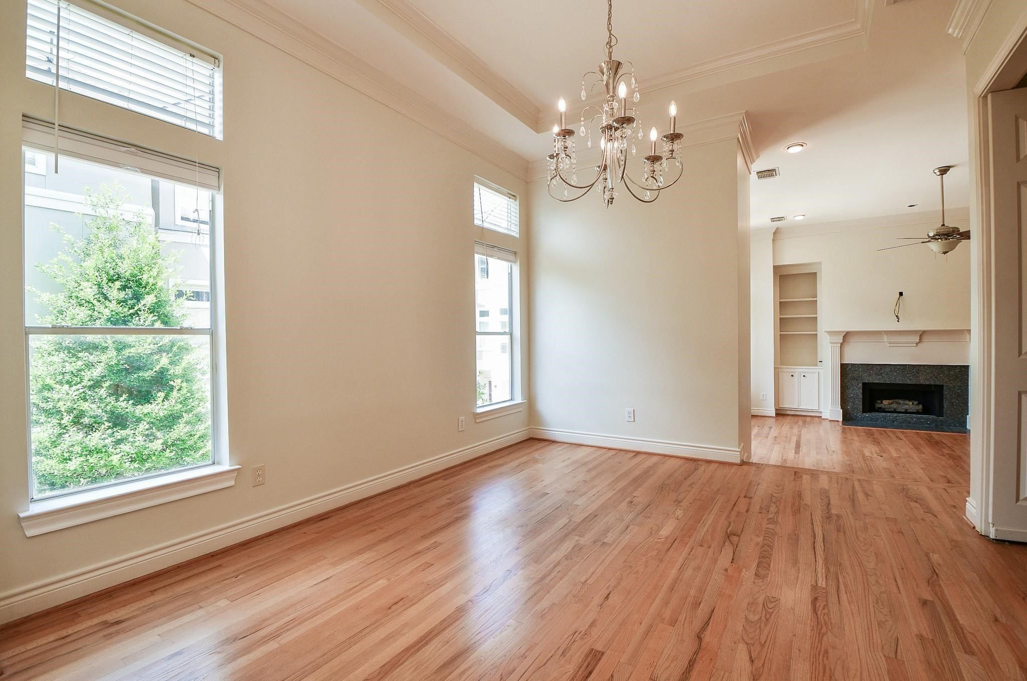 1025 Marconi Street Houston, TX 77019 - Photo 5 of 19 a view of an empty room with wooden floor and a window