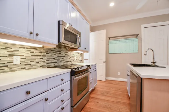 a kitchen with stainless steel appliances granite countertop a stove and a microwave
