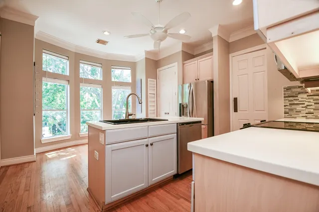 a kitchen with a stove a sink and a refrigerator