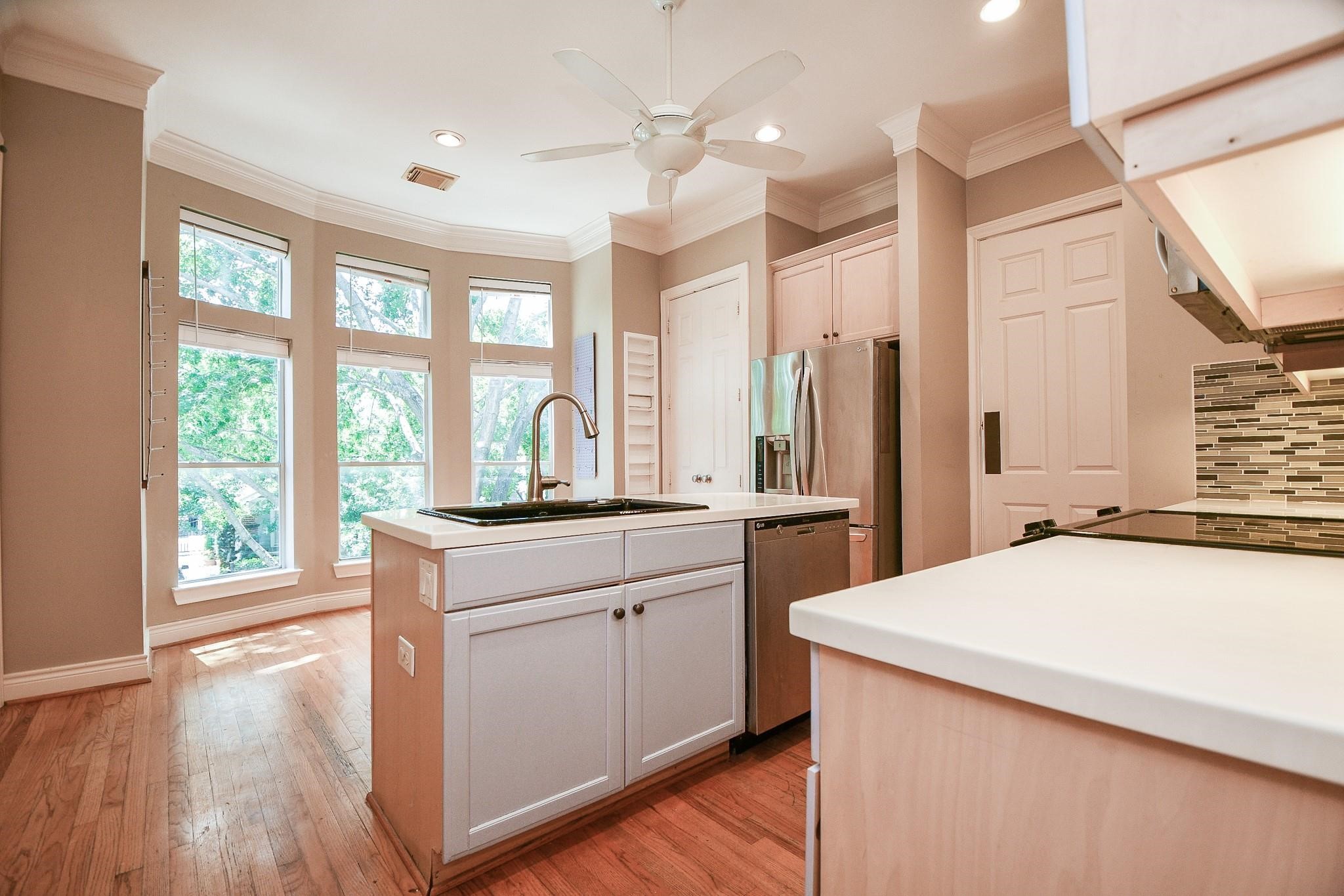1025 Marconi Street Houston, TX 77019 - Photo 8 of 19 a kitchen with a stove a sink and a refrigerator