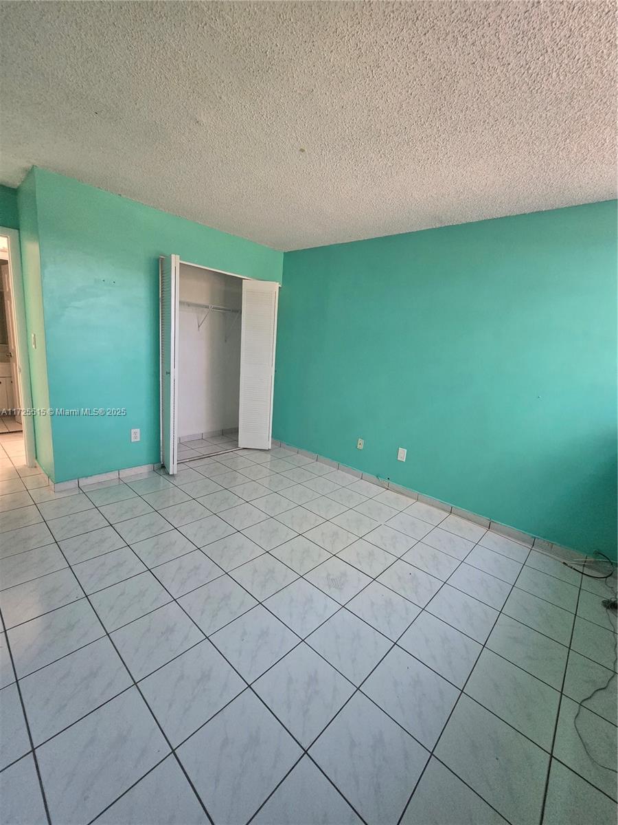 Fountainebleau Miami, FL 33172 - Photo 13 of 28 a bedroom with a bed and a window