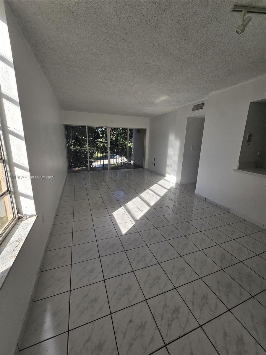 Fountainebleau Miami, FL 33172 - Photo 2 of 28 a view of a livingroom with an empty space and a window