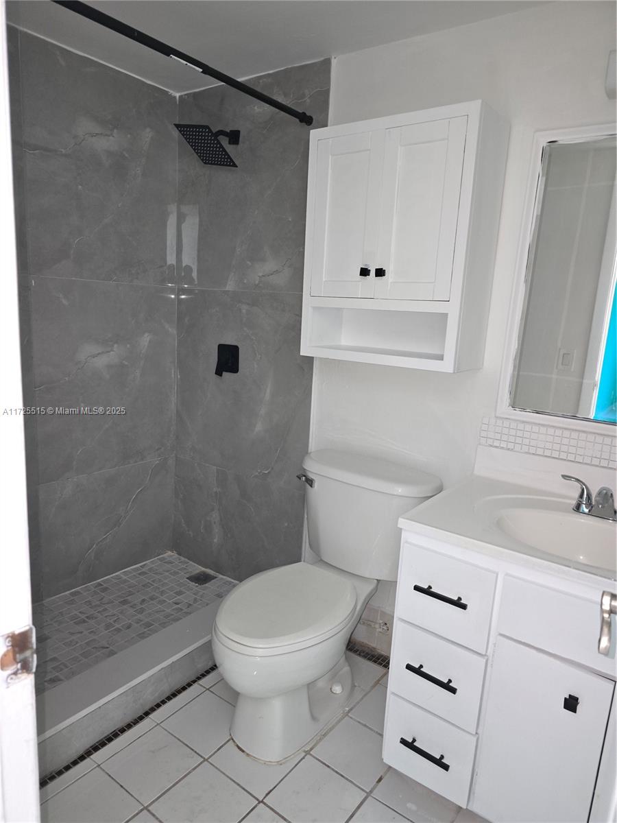 Fountainebleau Miami, FL 33172 - Photo 22 of 28 a bathroom with a sink a toilet and shower