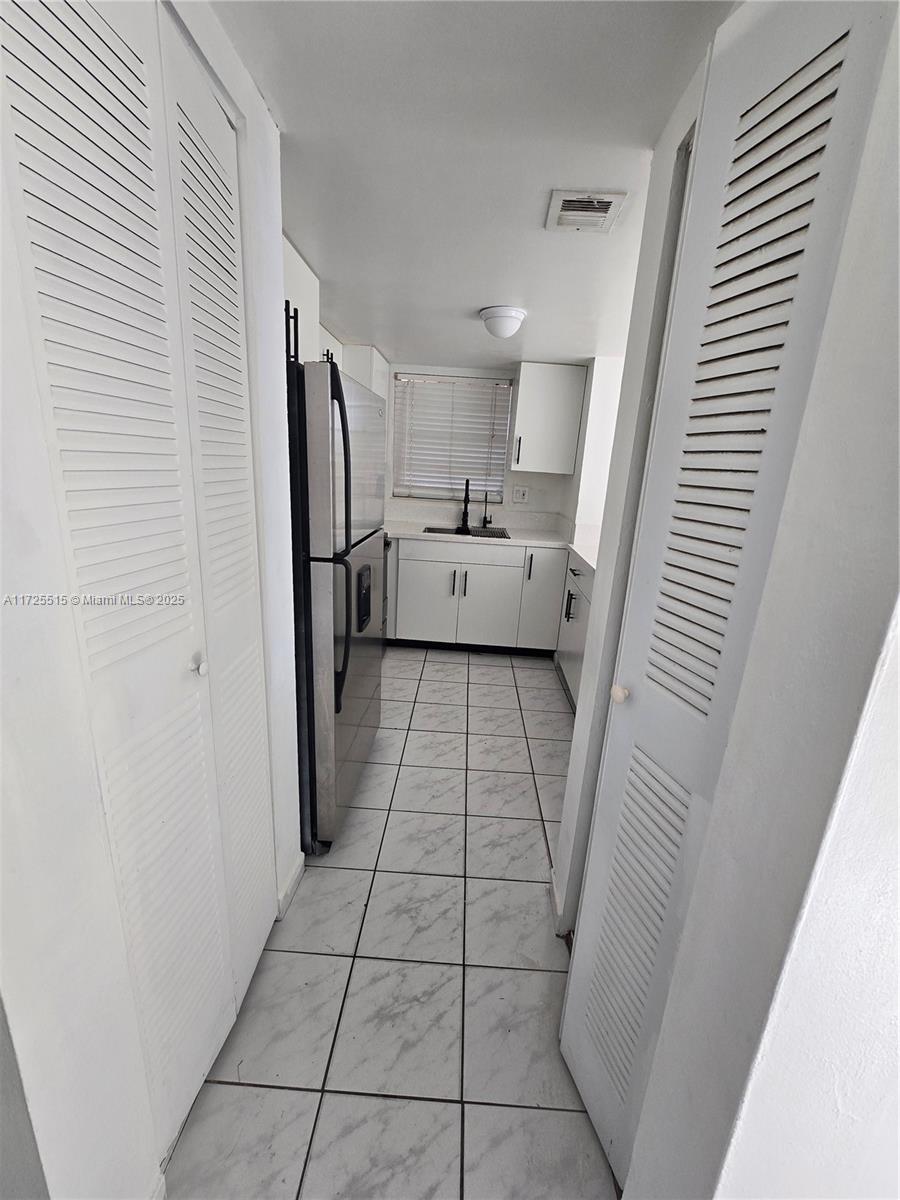 Fountainebleau Miami, FL 33172 - Photo 8 of 28 a view of a kitchen from the hallway