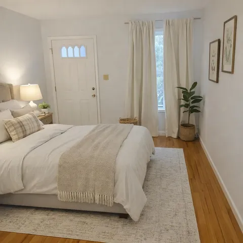 a bedroom with a bed and a potted plant
