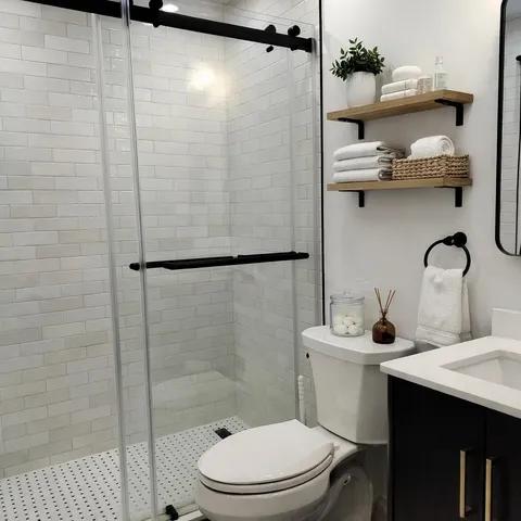 a bathroom with a sink a toilet and shower