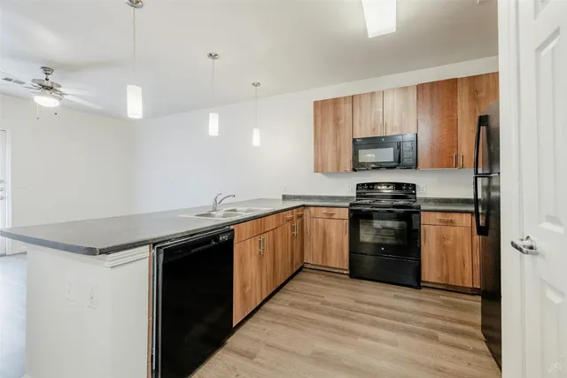 a kitchen with a sink appliances and cabinets