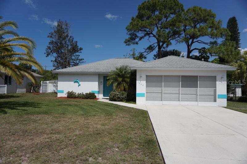 1200 Porpoise Road Venice, FL 34293 - Photo 1 of 1 a front view of a house with a garden and trees