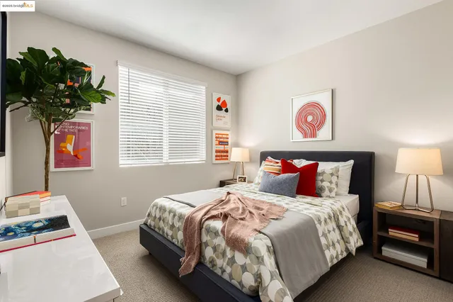 a bedroom with bed and a potted plant