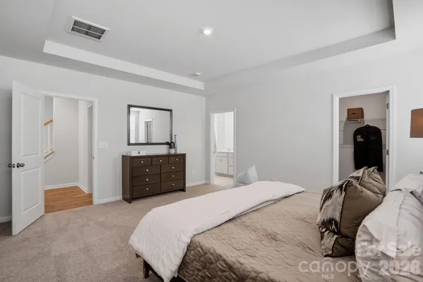 a bedroom with a bed and a walk in closet