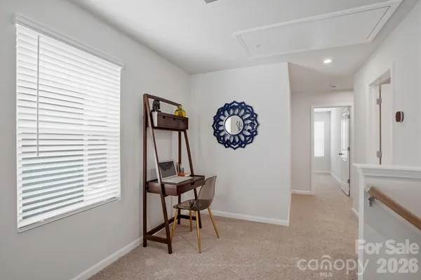 a view of a room with a window and wooden floor