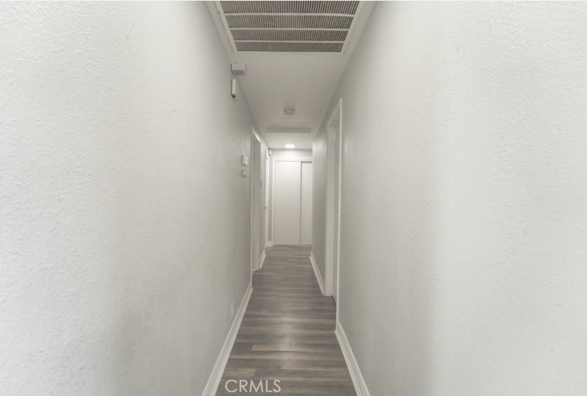 15032 Birch Street Hesperia, CA 92345 - Photo 11 of 21 a view of a hallway with wooden floor